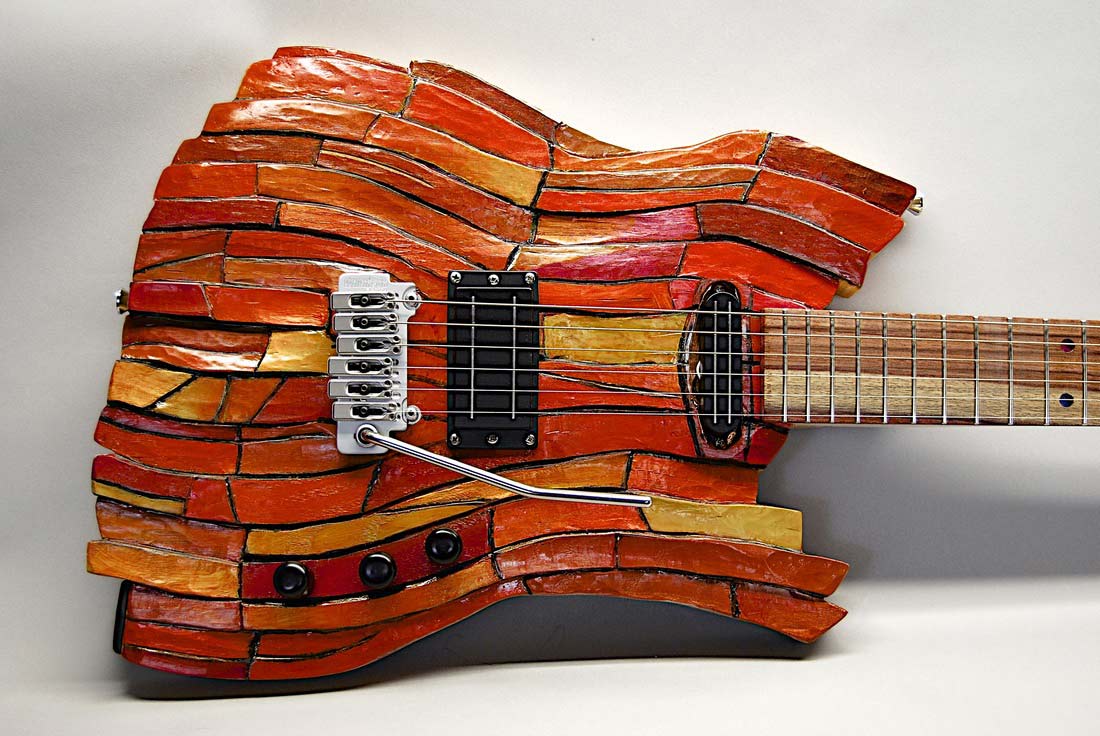 button - photo of primarily orange colored art guitar